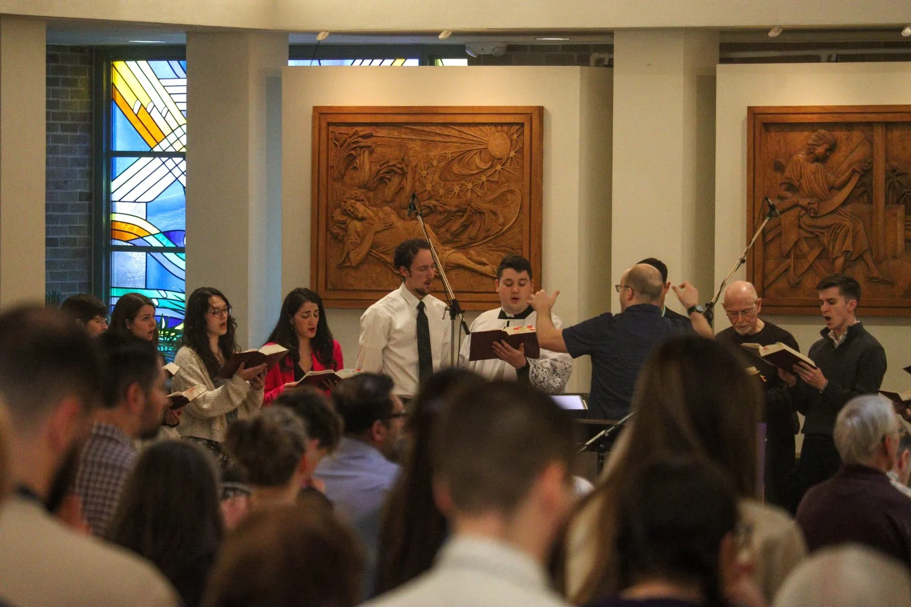 Peter Brown conducting singers in a church