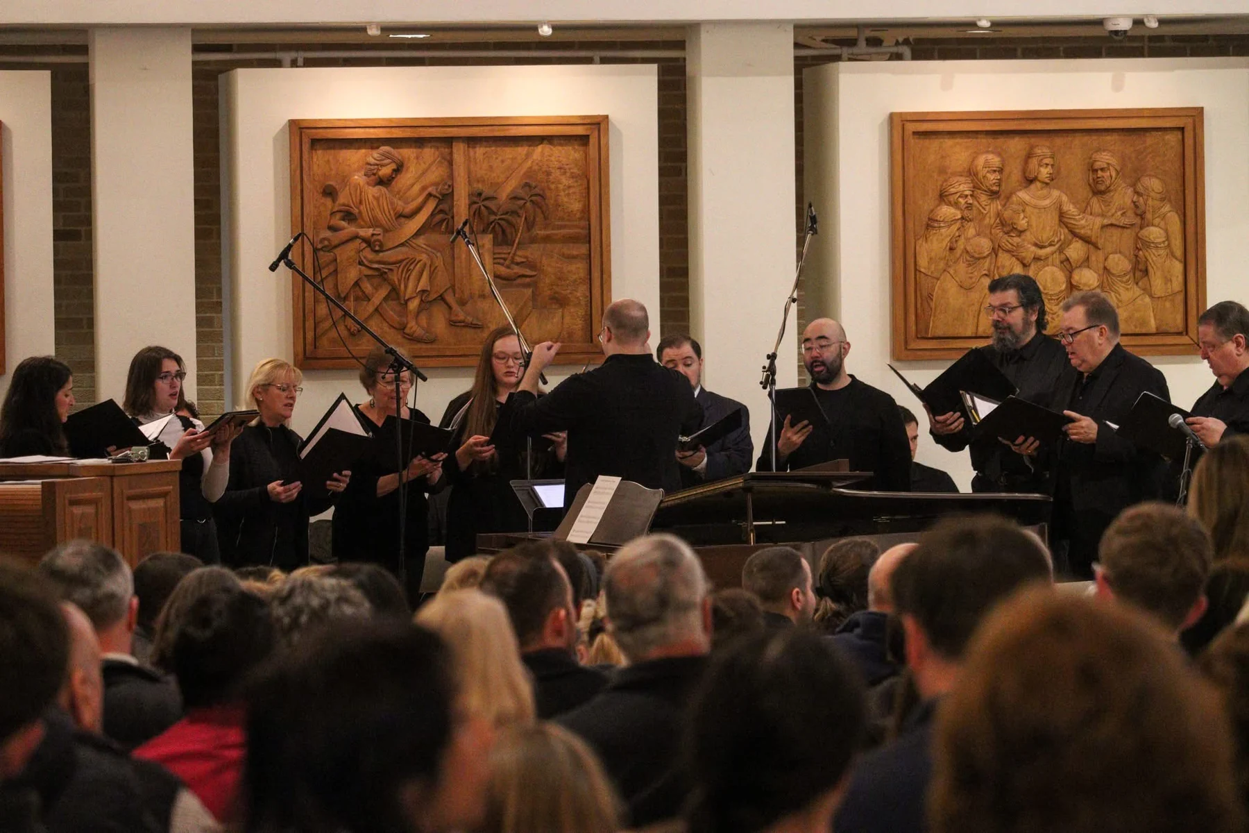 Peter Brown conducting a choir before a large audience